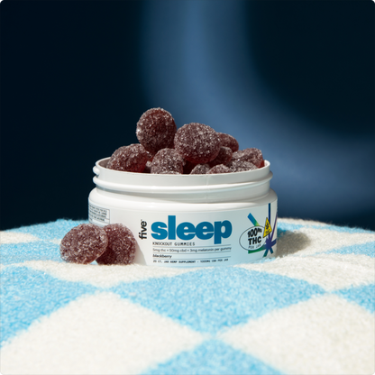 White jar labeled 'five sleep' and 'KNOCKOUT GUMMIES' filled with sugar-coated blackberry gummies; label reads '100 THC PER JAR'